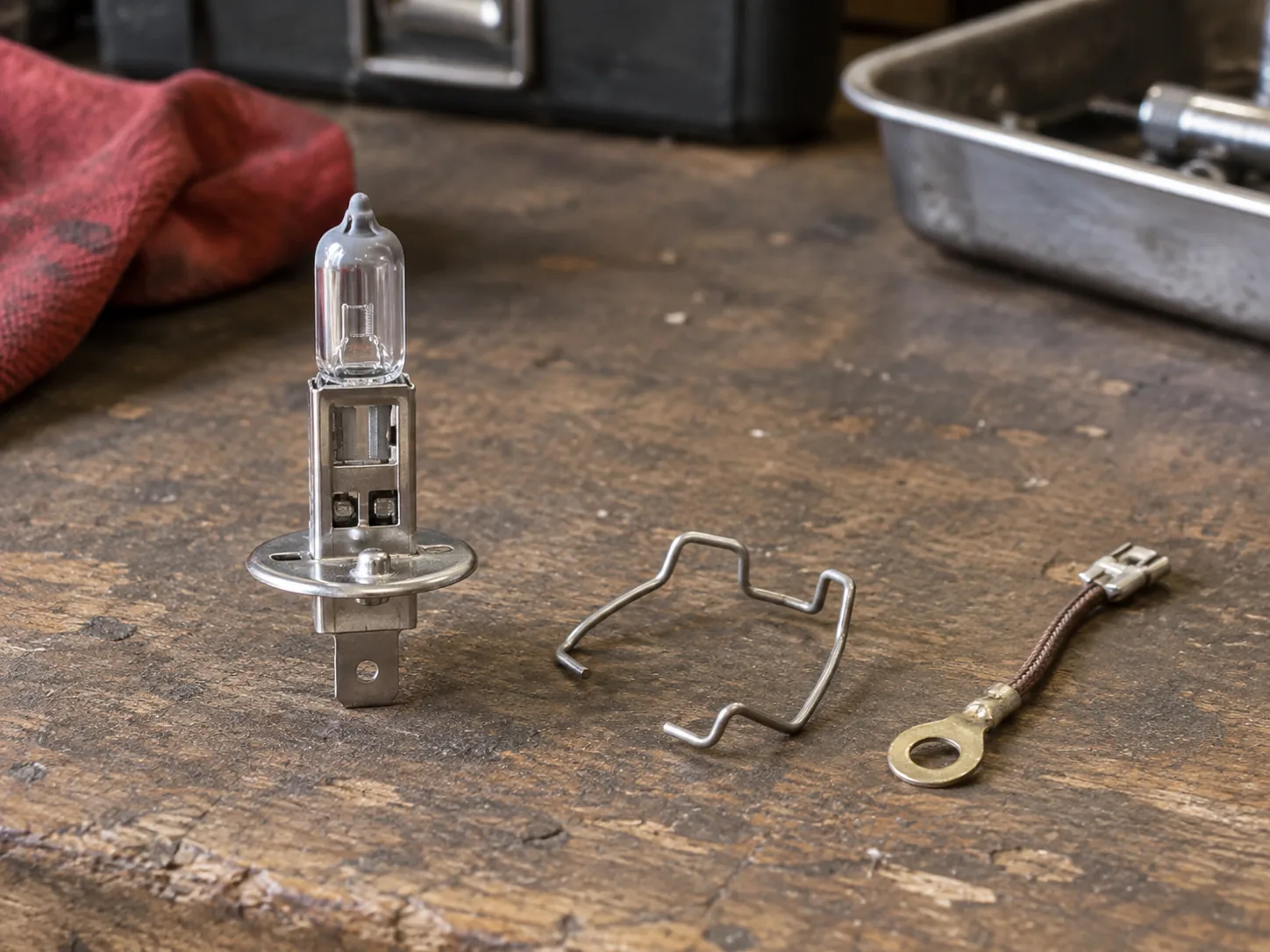 H1 automotive bulb beside a headlamp housing for fitment identification